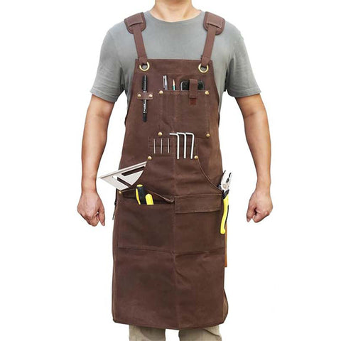 Man wearing brown heavy - duty work apron with multiple tool pockets, white background