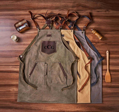 Dark gray canvas apron with tool pockets, close - up of leather and tool details