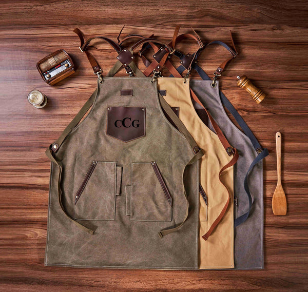 Dark gray canvas apron with tool pockets, close - up of leather and tool details