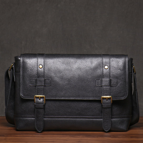 Black leather messenger bag, front view with gold buckles, sleek vintage aesthetic