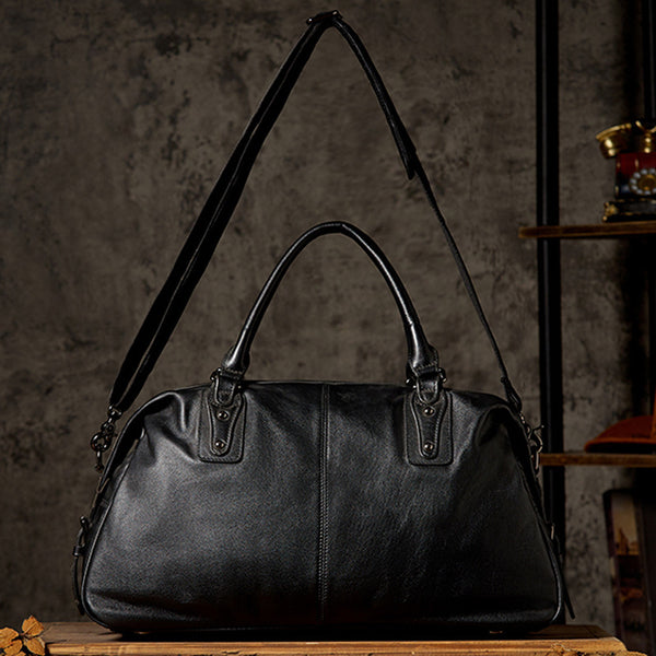 Black leather duffel bag with extended shoulder strap, showcasing versatile carry options
