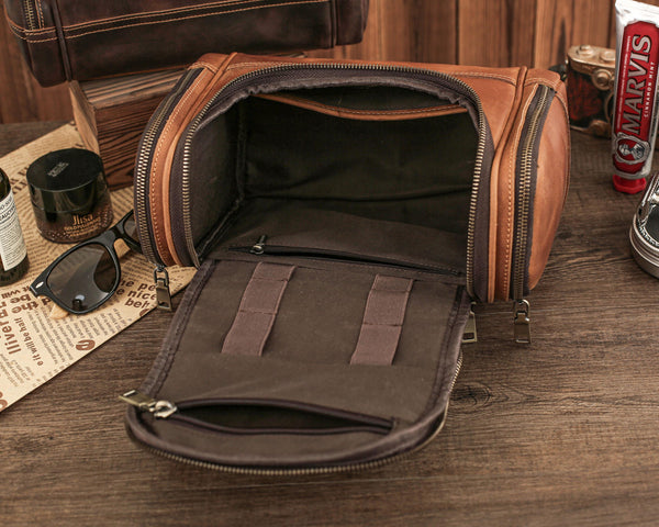 Interior of brown leather toiletry bag with multiple compartments and organizational slots