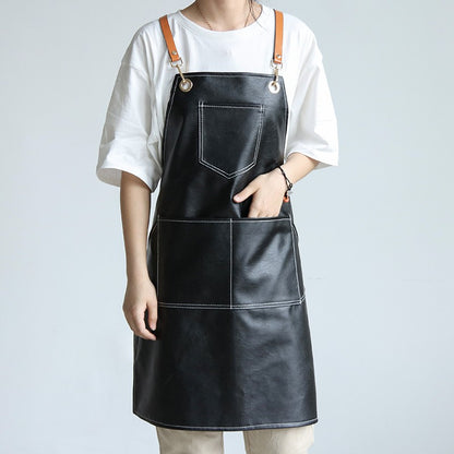 Woman wearing black PU leather apron with brown straps, white background